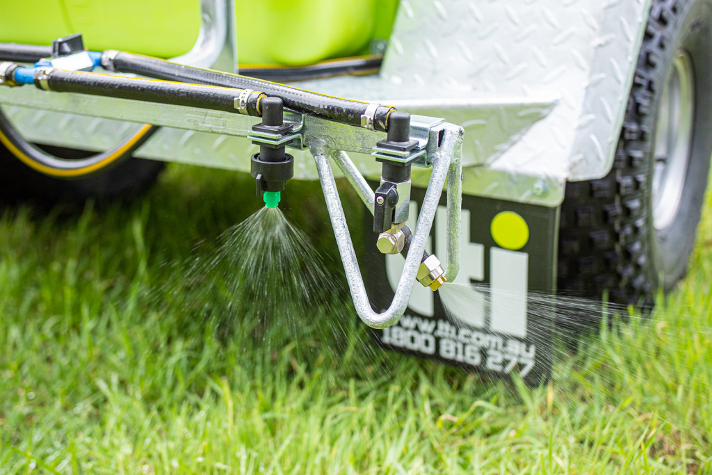 200L TrailPro™ 12v ATV Trailer Sprayer spraying water on plants