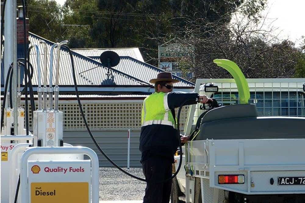 Man is transferring fuel to portable Diesel Fuel Tank Pod