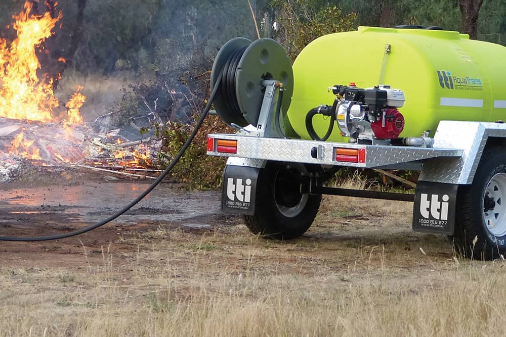 Fire hose reel on a truck next to a fire